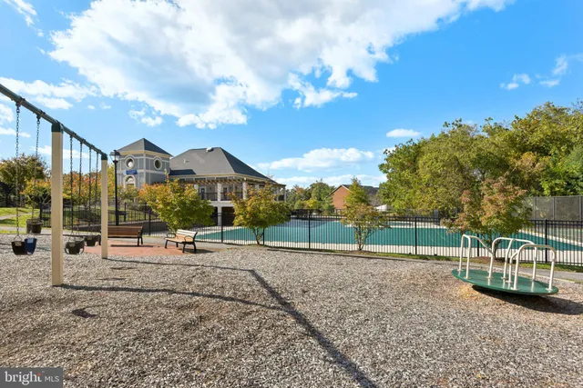 a view of outdoor space with playground and green space