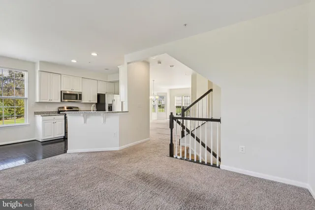 a view of kitchen with furniture and electronic appliances
