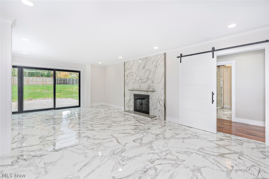 20601 Shelburne Road Shaker Heights, OH 44122 - Photo 3 of 29 Second level living room with a bright marble finish floors, ornamental molding, recessed lighting, and a fireplace
