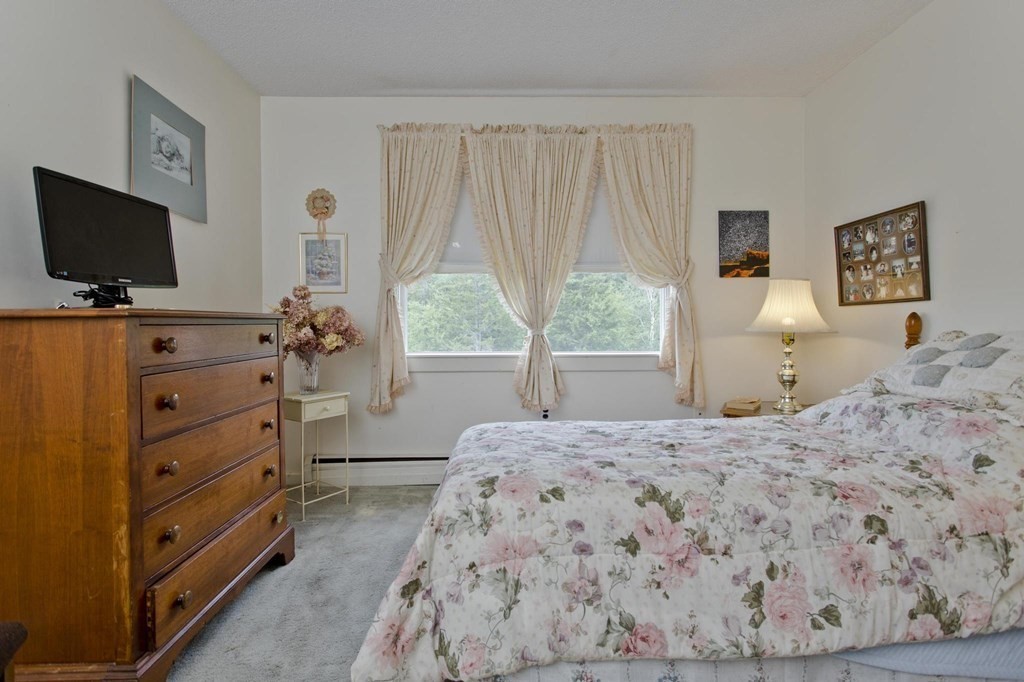 229 Number 9 Road Heath, MA 01367 - Photo 27 of 38 a bedroom with a bed and a flat screen tv