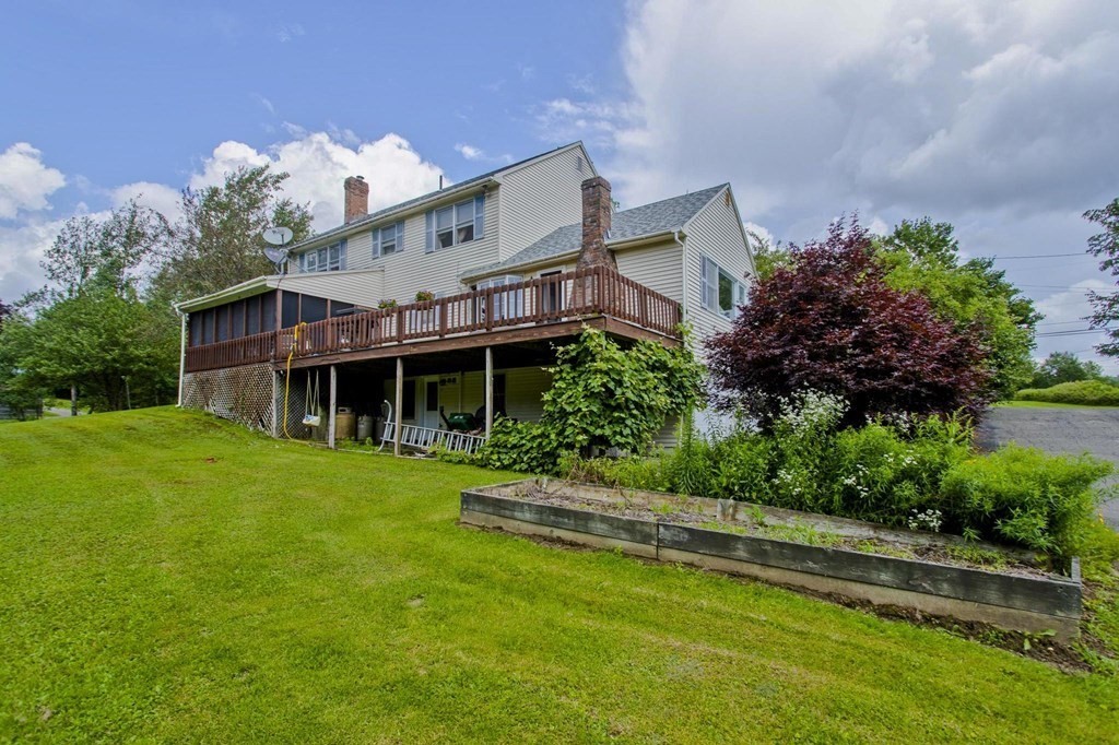 229 Number 9 Road Heath, MA 01367 - Photo 4 of 38 a front view of a house with a garden and plants