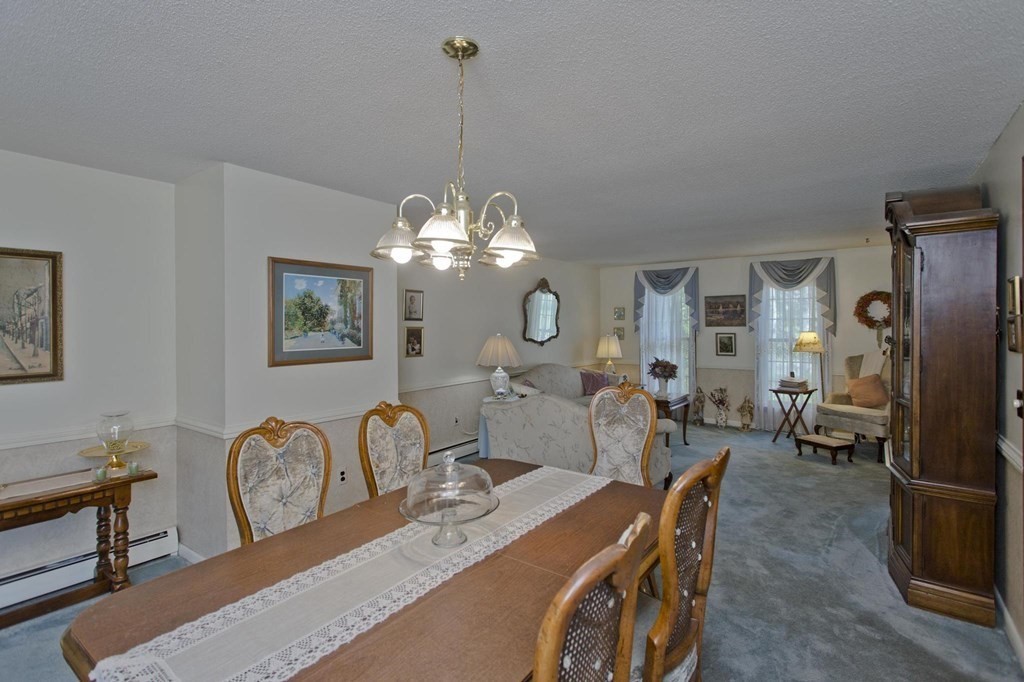 229 Number 9 Road Heath, MA 01367 - Photo 9 of 38 a view of a livingroom with furniture a chandelier and wooden floor