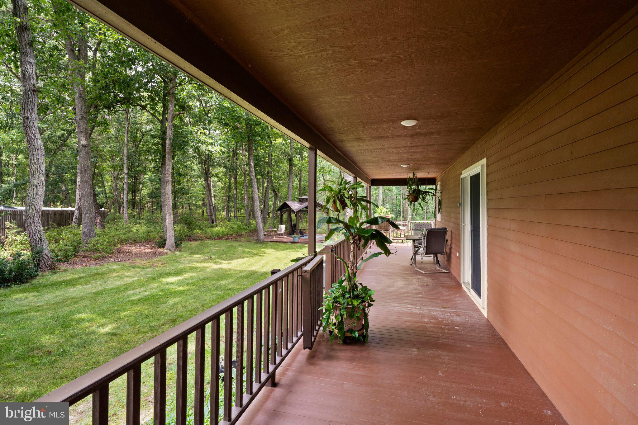 16 Dunhill Road Jackson, NJ 08527 - Photo 35 of 44 Serene porch overlooking lush greenery.