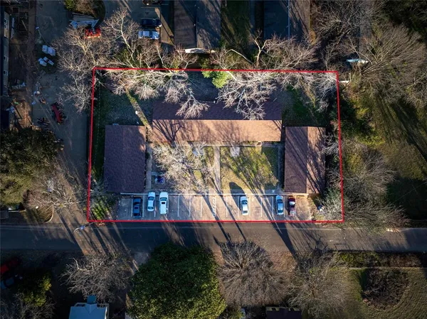 an aerial view of residential houses with outdoor space