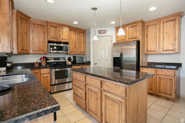 426 Deer Hollow Road Tooele, UT 84074 - Photo 8 of 37 Kitchen with appliances with stainless steel finishes, light tile patterned floors, a center island, decorative light fixtures, and recessed lighting