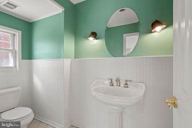 2712 Mower Street Philadelphia, PA 19152 - Photo 12 of 27 a bathroom with a sink and mirror with toilet