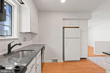 2712 Mower Street Philadelphia, PA 19152 - Photo 20 of 27 a kitchen with granite countertop white cabinets and stainless steel appliances