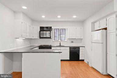 2712 Mower Street Philadelphia, PA 19152 - Photo 21 of 27 a kitchen with granite countertop a sink stove and refrigerator