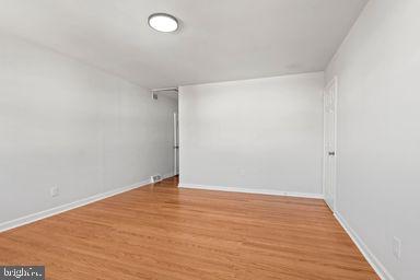 2712 Mower Street Philadelphia, PA 19152 - Photo 9 of 27 an empty room with wooden floor and windows