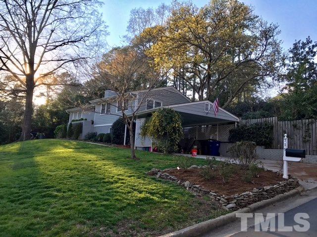 719 Beaver Dam Road Raleigh, NC 27607 - Photo 1 of 13 a view of a garden with a bench and trees