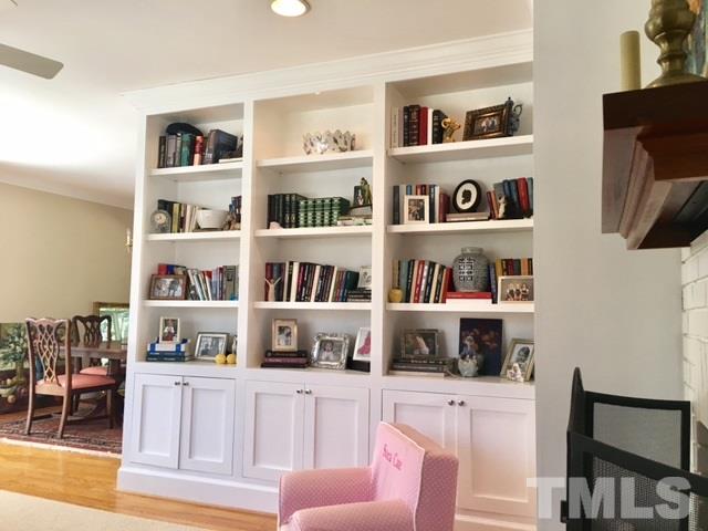 719 Beaver Dam Road Raleigh, NC 27607 - Photo 3 of 13 a cabinet with a book shelf and a shelf with books