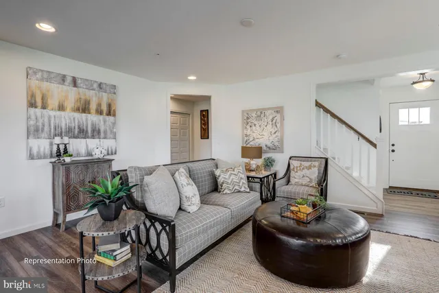 a living room with furniture and a potted plant