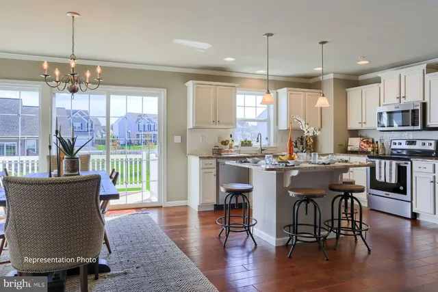 a dining room with furniture a chandelier and wooden floor