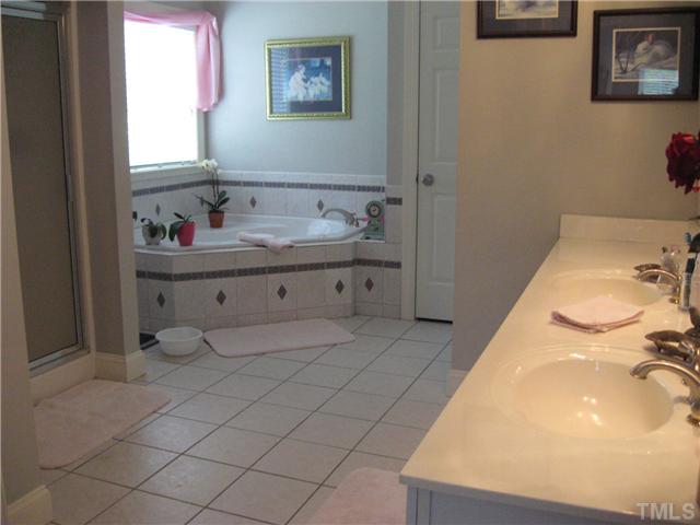 1001 Fieldgrass Place Raleigh, NC 27603 - Photo 3 of 20 NOW THIS IS A BATHROOM! SPACIOUS, LIGHT, GORGEOUS, FROSTED WINDOW FOR PRIVACY KING SIZED GARDEN TUB AND SEPERATE SHOWER, LINEN CLOSET