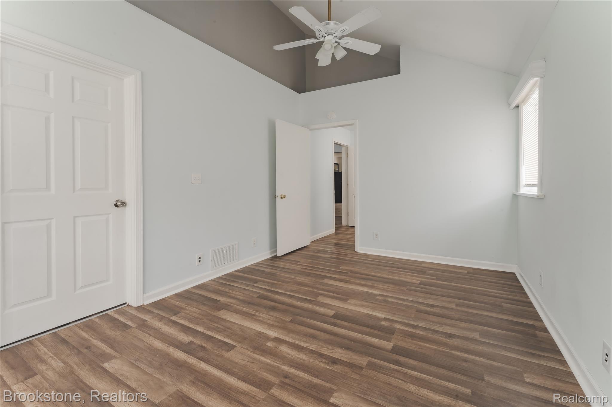 202 West Rundell Street Pontiac, MI 48342 - Photo 17 of 27 Primary Bedroom with ceiling fan, vaulted ceiling, and dark wood-style flooring