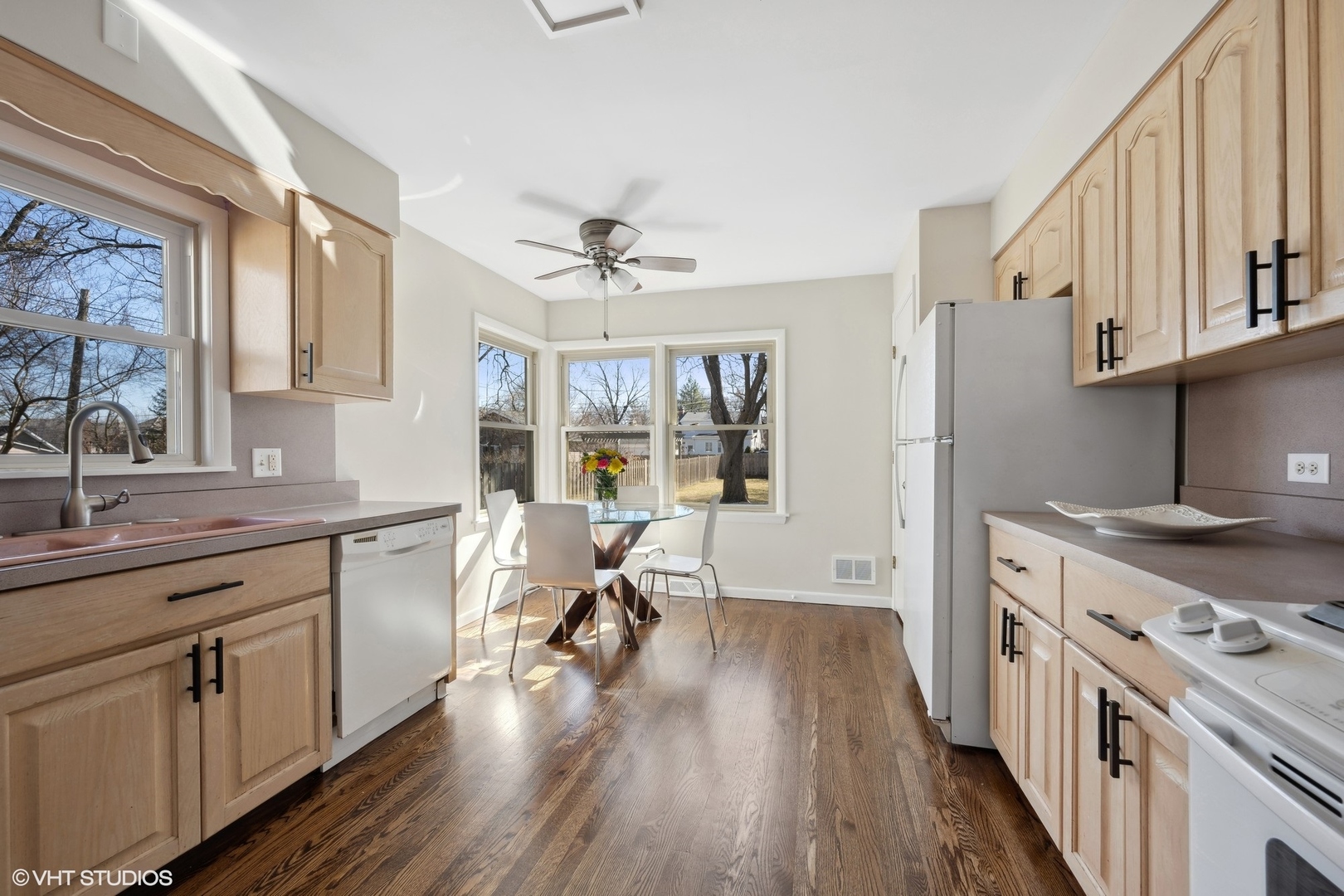 2237 Dewes Street Glenview, IL 60025 - Photo 6 of 20 a open kitchen with stainless steel appliances granite countertop a stove top oven a sink dishwasher and white cabinets with wooden floor