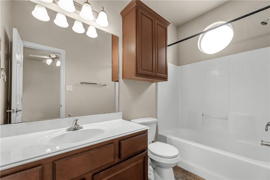 1198 Jones-Butler Road, Unit 606 College Station, TX 77840 - Photo 13 of 32 a bathroom with a sink a toilet and a mirror