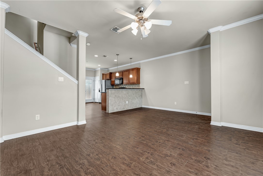 1198 Jones-Butler Road, Unit 606 College Station, TX 77840 - Photo 6 of 32 a view of a livingroom with wooden floor and a ceiling fan