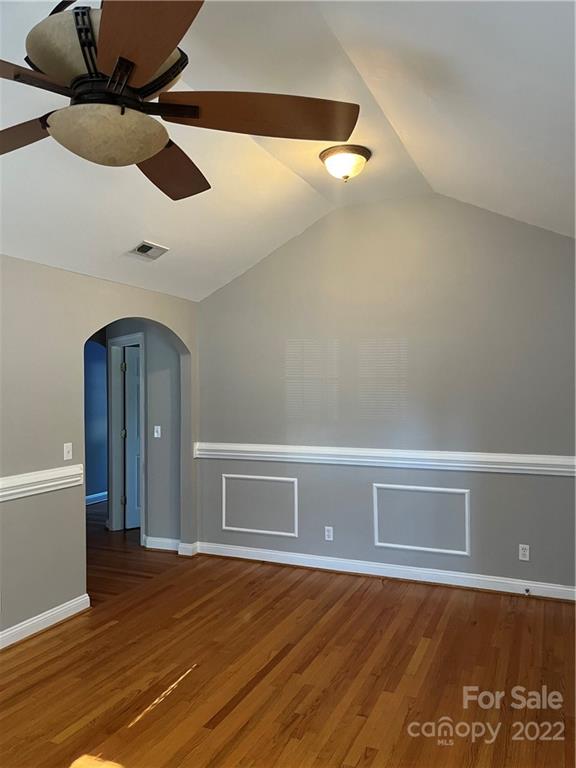 3501 Ritch Avenue Charlotte, NC 28206 - Photo 3 of 18 a view of an empty room with wooden floor and a ceiling fan