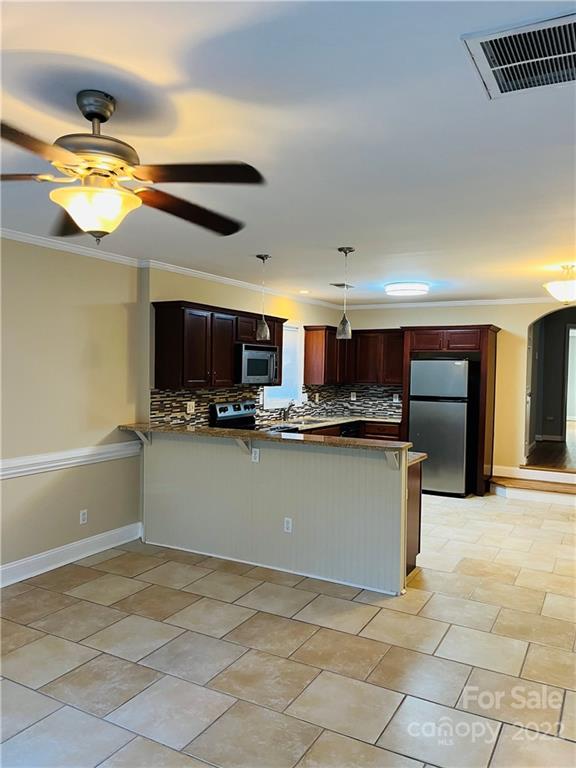 3501 Ritch Avenue Charlotte, NC 28206 - Photo 8 of 18 a kitchen with stainless steel appliances granite countertop a refrigerator and a stove top oven