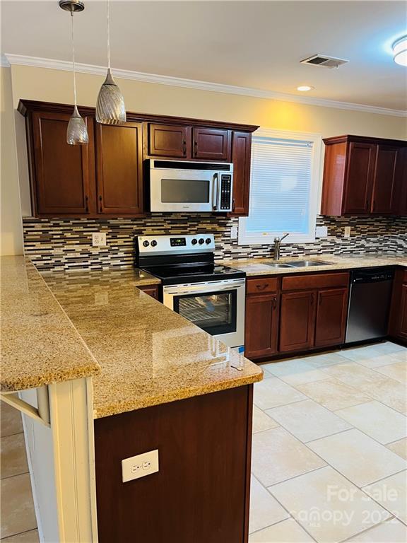 3501 Ritch Avenue Charlotte, NC 28206 - Photo 10 of 18 a kitchen with stainless steel appliances granite countertop a sink stove and microwave