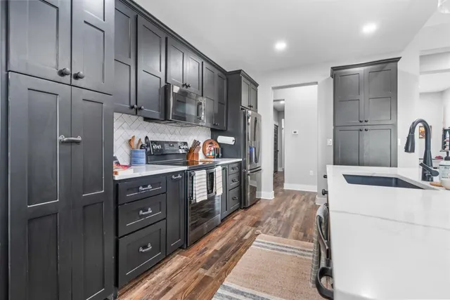 a kitchen with a refrigerator and cabinets