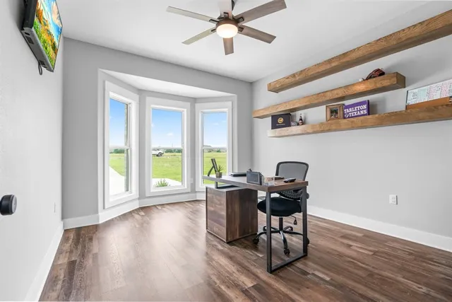 a work room with furniture and wooden floor