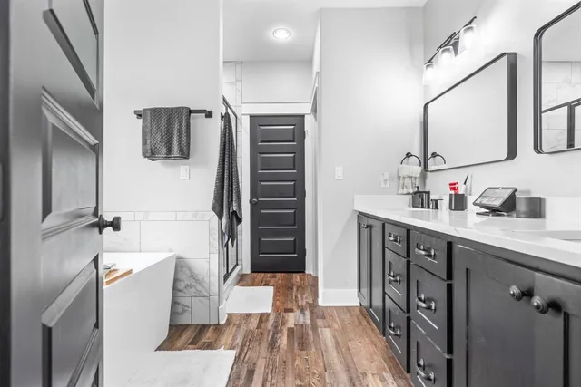 a bathroom with a sink a mirror and shower