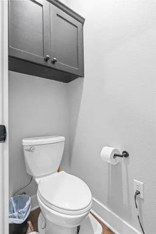 a bathroom with a toilet a sink and mirror