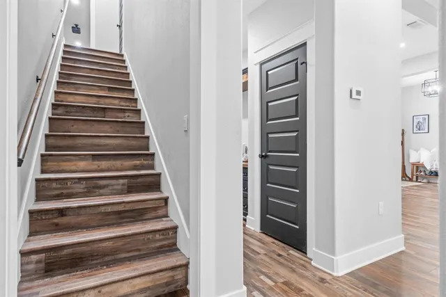 a view of an entryway with wooden floor and stairs