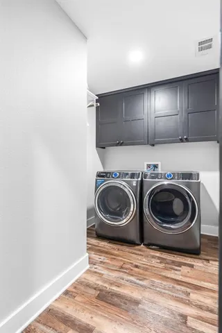 a utility room with sink dryer and washer