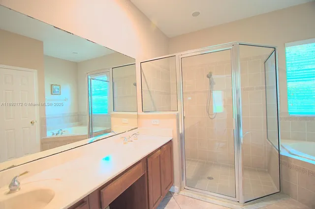 a bathroom with a bathtub and a shower