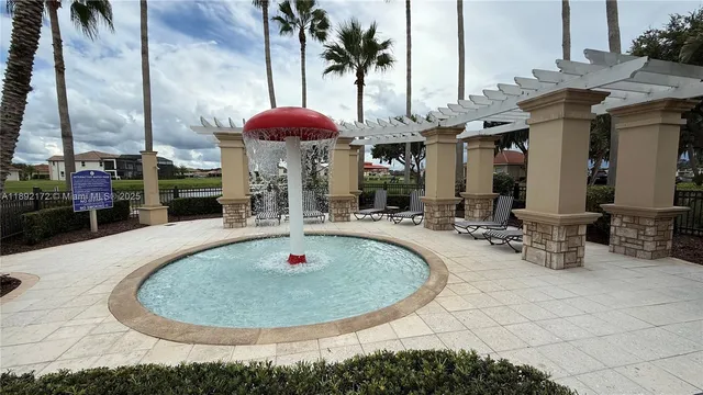 an open kitchen with wooden floor and refrigerator