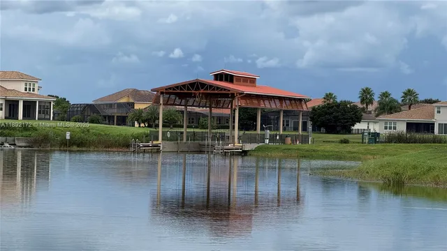 an aerial view of a house with swimming pool and outdoor seating