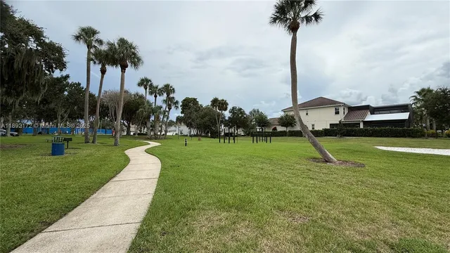 a view of street with houses and trees in the background