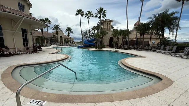 an aerial view of a house with a garden and lake view