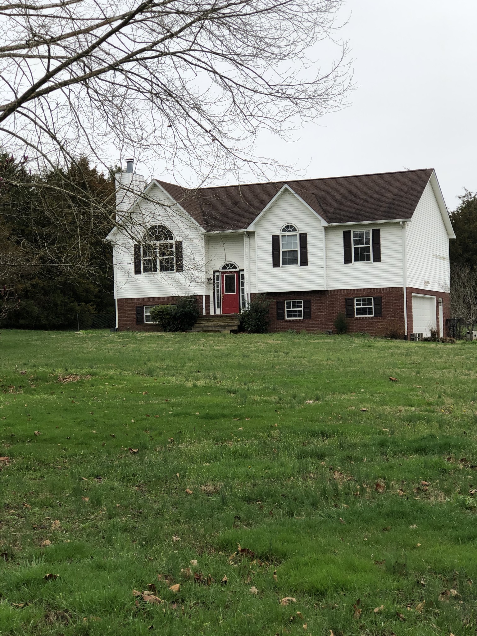 5116 Kedron Road Columbia, TN 38401 - Photo 1 of 10 a house that is sitting in the grass with large trees and plants