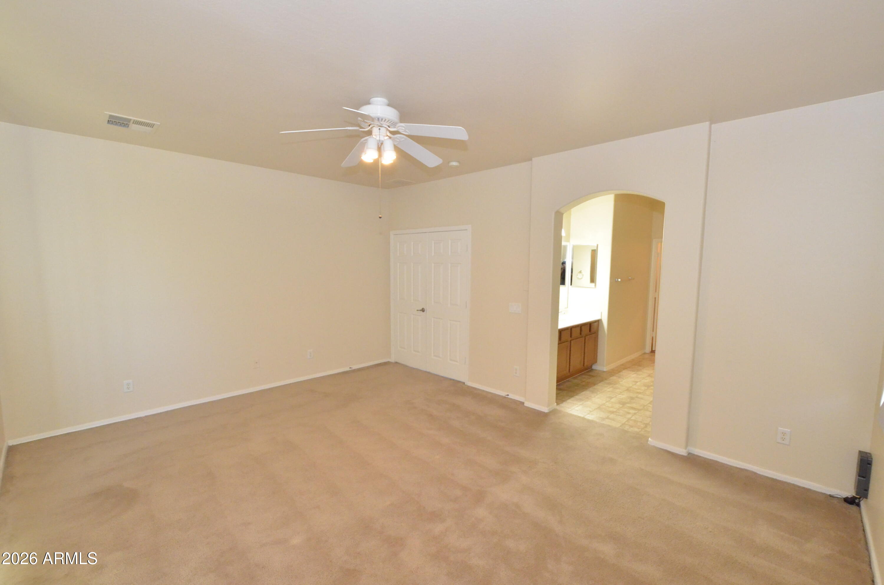 3995 East Trigger Way Gilbert, AZ 85297 - Photo 9 of 23 an empty room with a empty space and a ceiling fan