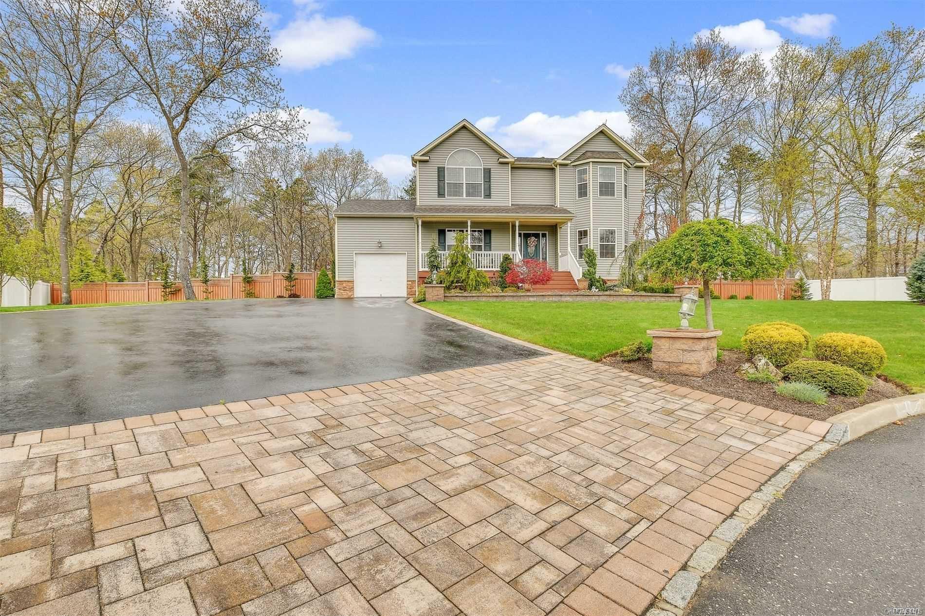 a view of a big house with a big yard and large trees