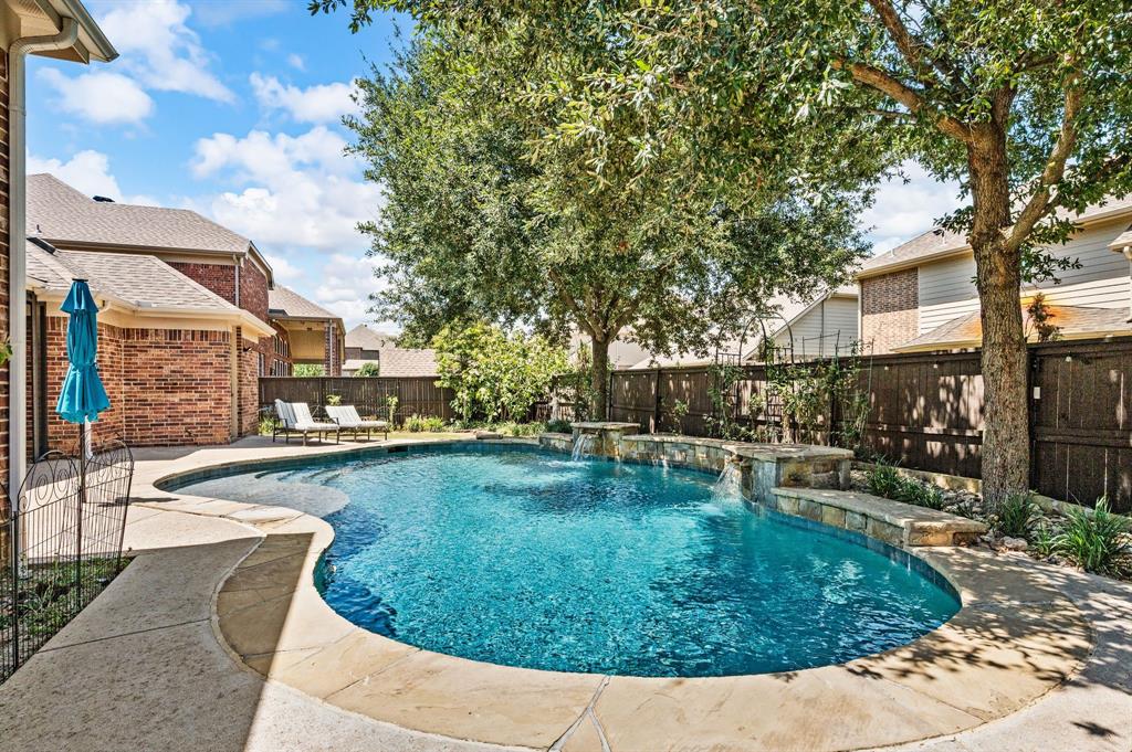 1521 Newton Ranch Road Keller, TX 76248 - Photo 37 of 40 Custom-shaped swimming pool with integrated waterfalls, and ample surrounding hardscaping