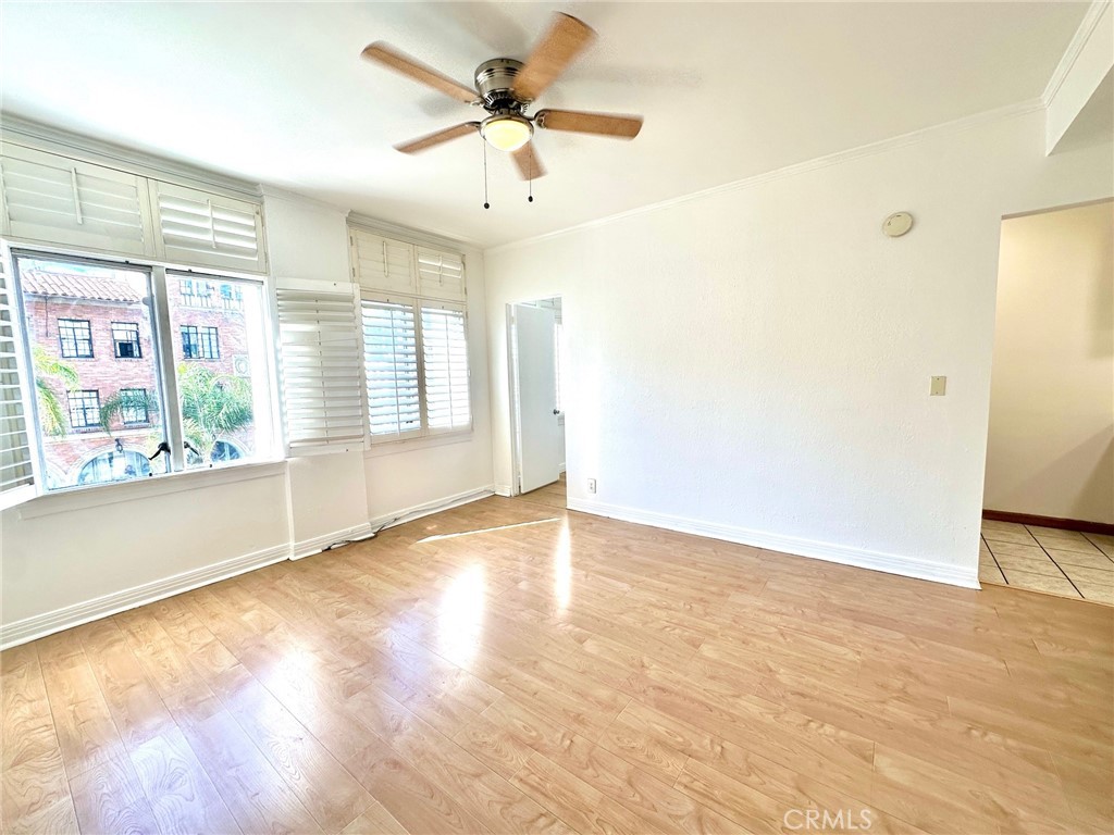 140 Linden Avenue, Unit 316 Long Beach, CA 90802 - Photo 4 of 11 an empty room with wooden floor and windows