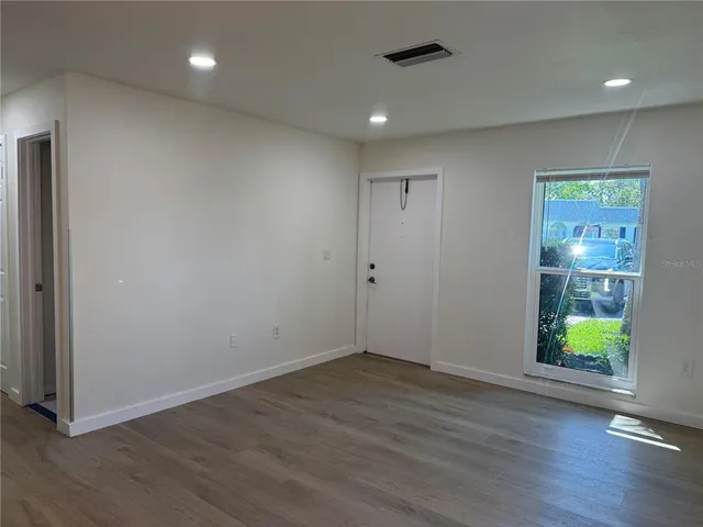 an empty room with windows and entrance