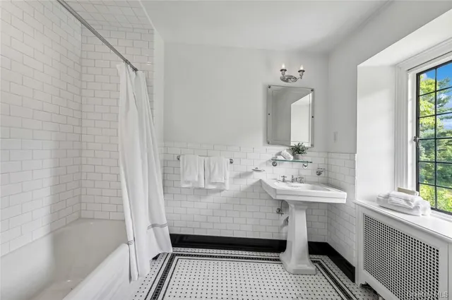a bathroom with a sink a mirror and shower