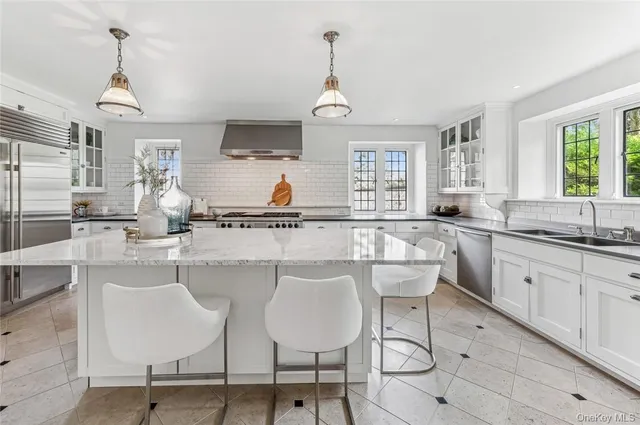 a kitchen with stainless steel appliances a sink and cabinets