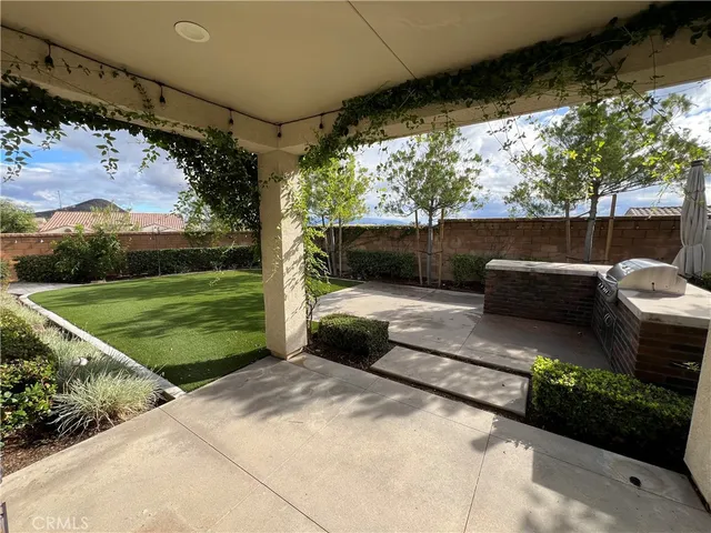 a view of swimming pool with a couches in a patio