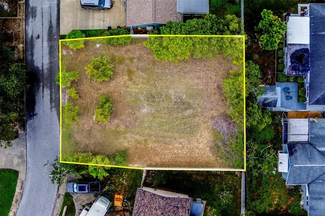 an aerial view of a house with a yard basket ball court and outdoor seating