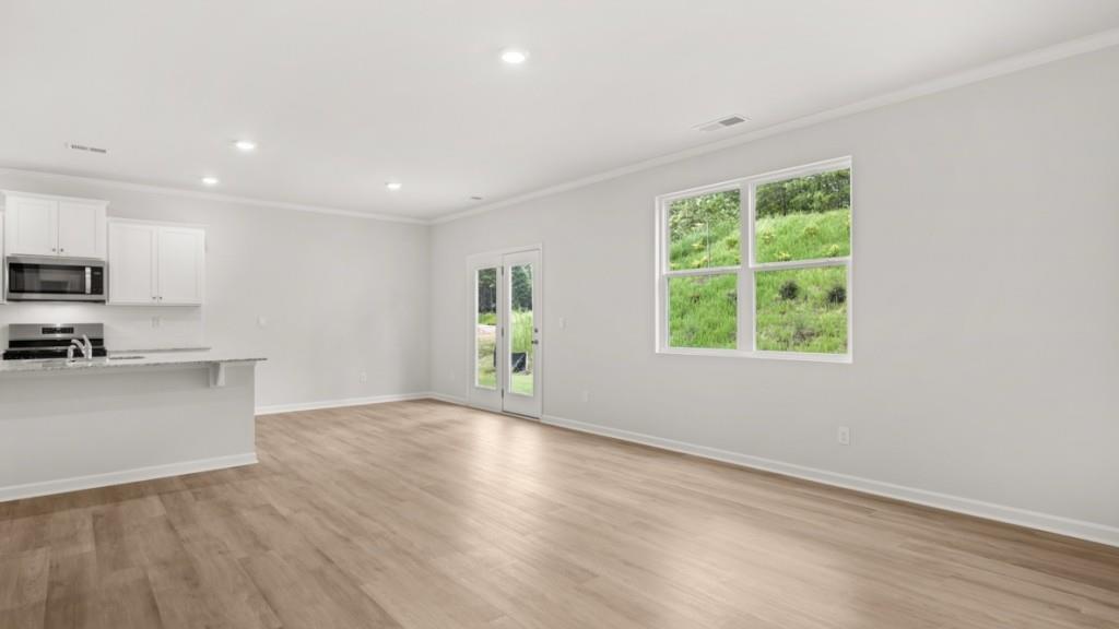 6008 Muirfield Point Union City, GA 30213 - Photo 11 of 29 a view of an empty room with a window and wooden floor