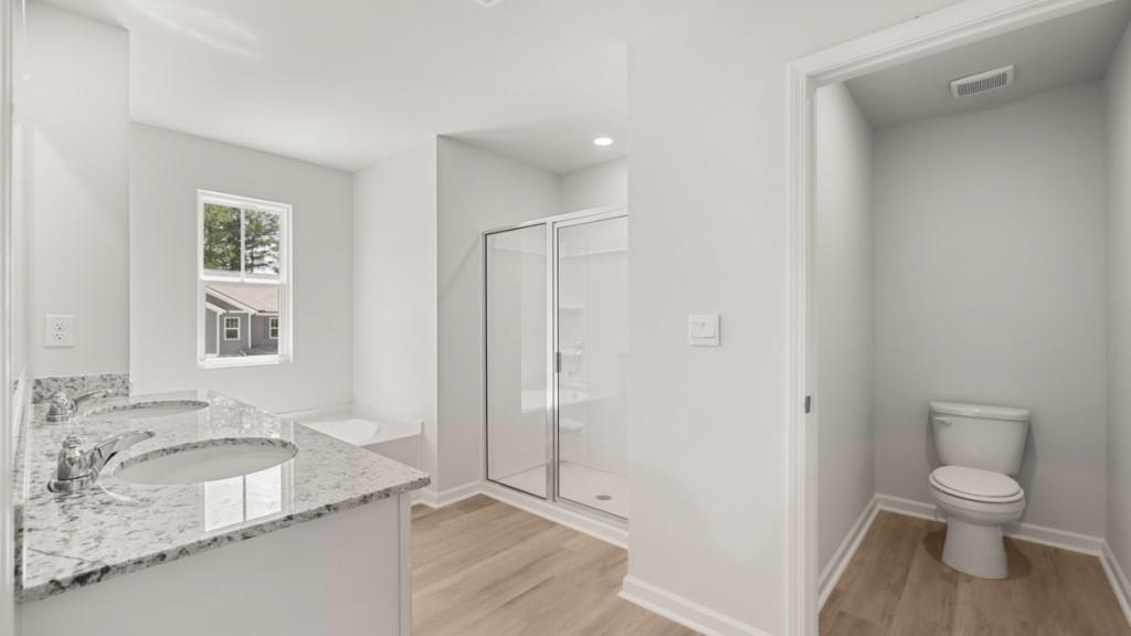 6008 Muirfield Point Union City, GA 30213 - Photo 16 of 29 a bathroom with a granite countertop sink toilet and shower