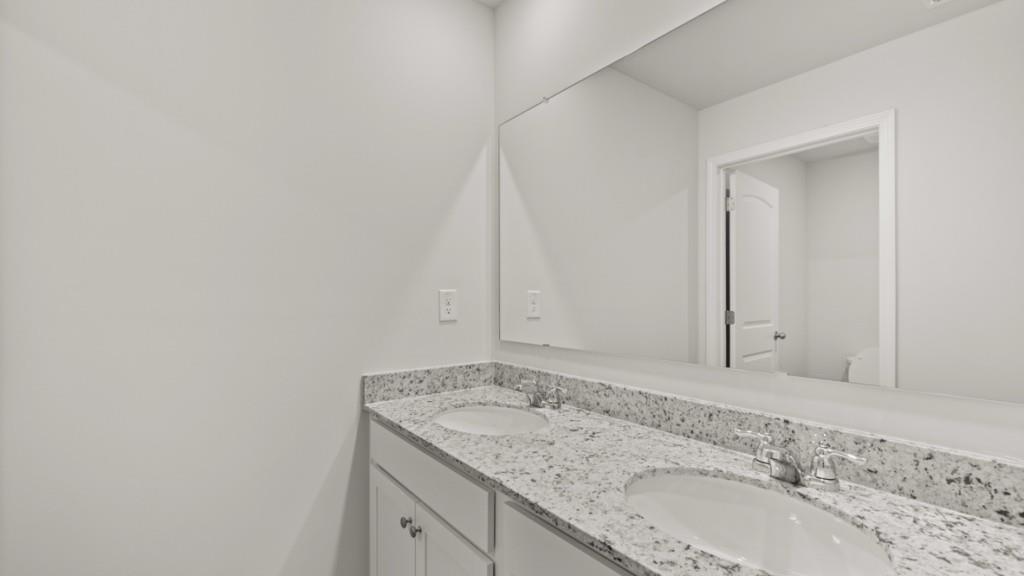 6008 Muirfield Point Union City, GA 30213 - Photo 22 of 29 a bathroom with a granite countertop sink and vanity