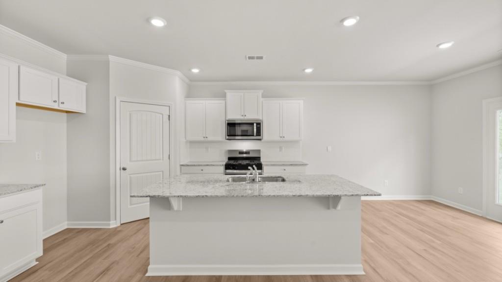 6008 Muirfield Point Union City, GA 30213 - Photo 4 of 29 a kitchen with stainless steel appliances granite countertop a stove a sink and a refrigerator